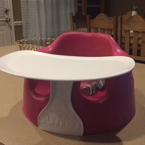 Pink Bumbo seat with tray.
